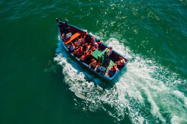 January 20, 2022. Florianopolis, Brazil. Touristic boats near Ponta das Campanhas with group of people are going to Campeche island. Aerial view.