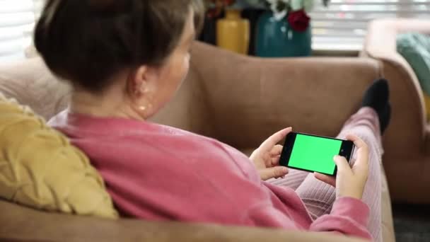 Ung Kvinde Derhjemme Liggende Sofa Ved Hjælp Green Mock Screen – Stock-video