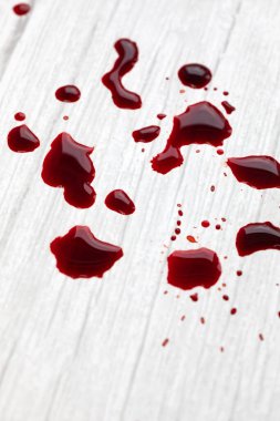 Beyaz ahşap arka planda kan lekeleri, damlayan ve sıçrayan kan. Kopya alanı, yaralanma yarası, metin için kavram alanı.