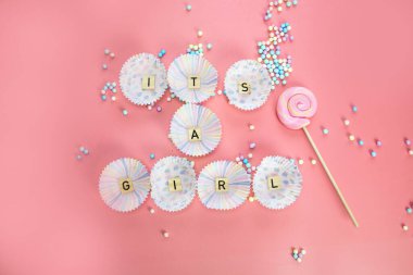 Bebek daveti için pembe tüylü ahşap arkaplan dokusu üzerine bir kız metni. Ya da yeni doğmuş bebek için. Kız duyuru kartı.