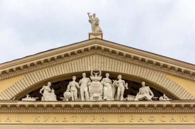 Minsk, Belarus, 04.11.21. Classical style pediment with workers sculptures, Trade Unions Palace of Culture building.