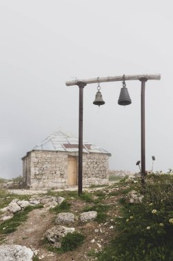 Gürcistan 'daki Khvamli Dağı' ndaki eski Ortodoks Aziz Giorgi Kilisesi. İki çanı ve sisli havası olan basit ahşap çan kulesiyle..