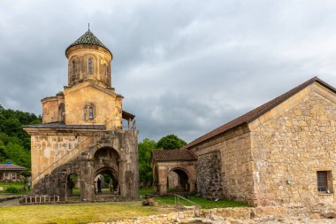 Gelati Monastery belfry (bell tower), medieval monastic complex near Kutaisi, Georgia founded by King David IV, stone walls with green tile roofs.