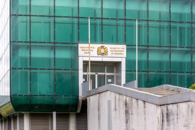 Kutaisi, Georgia, 06.06.21. Entrance to the House of the Government of Georgia in Kutaisi, modern green glass abandoned building with Coat of arms of Georgia.