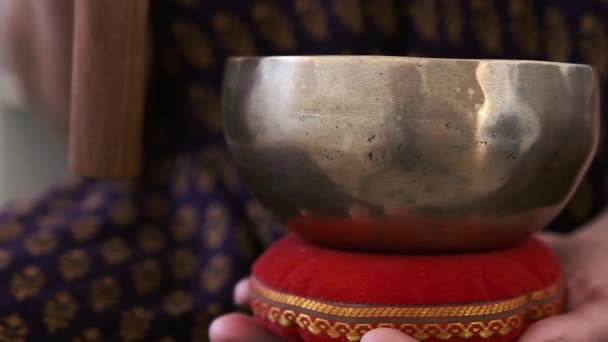 A girl holds a Tibetan bowl in her hands — Video