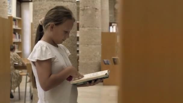 Girl Looks Books Library — Stock Video