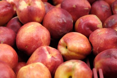 juicy red peaches on the store shelf