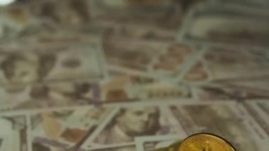 a few coins of cryptocoins on US dollars against the background of police red and blue flashing