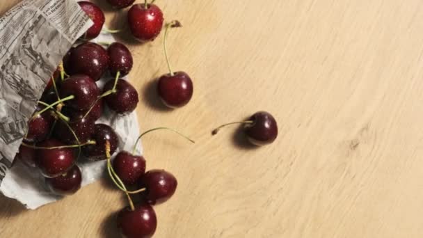 Table Ripe Cherries Scattered Newspaper Bag — 图库视频影像