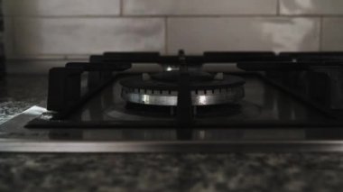 a fire is lit on the gas stove
