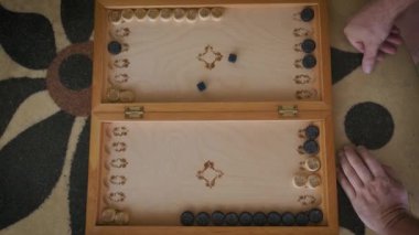 backgammon video boards on top during the game of a boy and a man