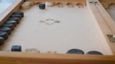 backgammon game throwing dice close-up movement of chips