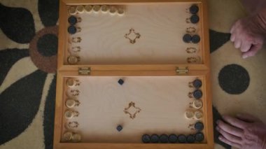 backgammon video boards on top during the game of a boy and a man