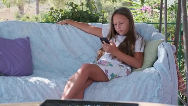 Girl Sitting Terrace Playing Games Gadget — Stockvideo