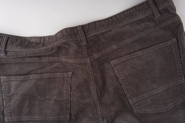 De achterkant van een donkere corduroy broek. Zakken zijn zichtbaar. Sluiten — Stockfoto