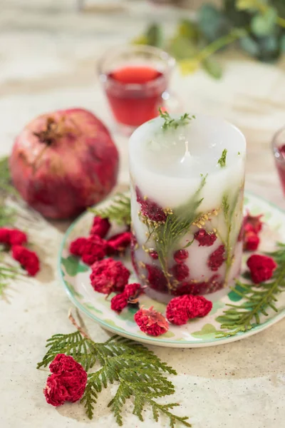 Handmade candles with dried flowers unique design. Scented candles decorated by dry leafs and blooms. Selective focus