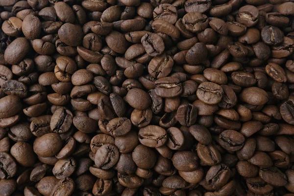Kavrulmuş kahve çekirdekleri yakın çekim doku arka planı