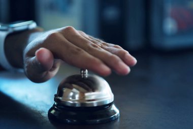 Hand slamming ready bell in a restaurant, hotel or reception