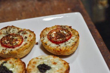 Close up photo of appetizers with mozzarella and tomatoes