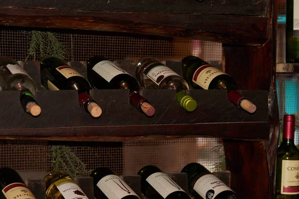 Collection of win bottles stacked in winery