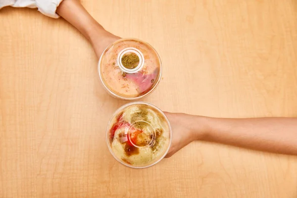 Top View Photo Two Female Friends Hands Holding Smoothies Wooden — стоковое фото