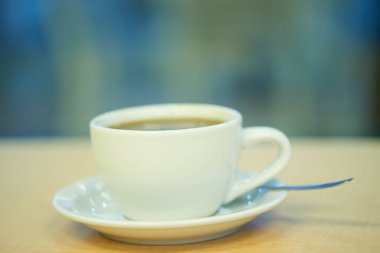 Kahve fincanı, bir barda ahşap tezgahın camına yakın çekim.