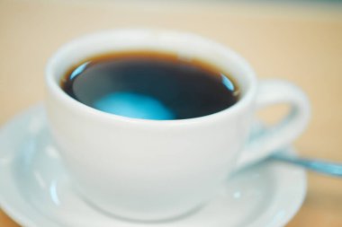 Kahve fincanı, bir barda ahşap tezgahın camına yakın çekim.