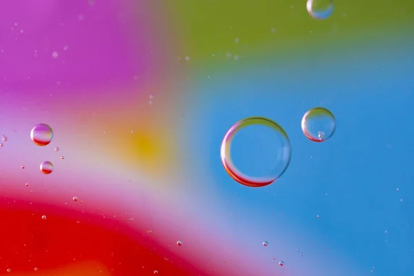 Abstract droplets oil bubbles on the water colorful background, macro photography oil bubbles surface