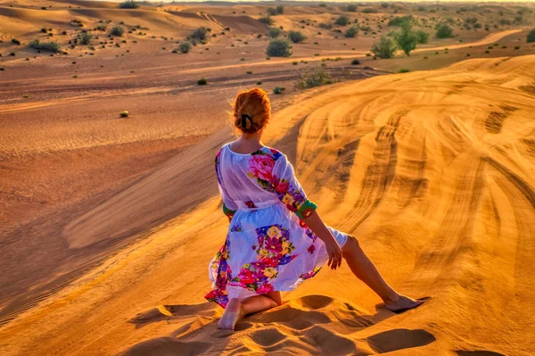 A woman in desert during sunset in Dubai, UAE.