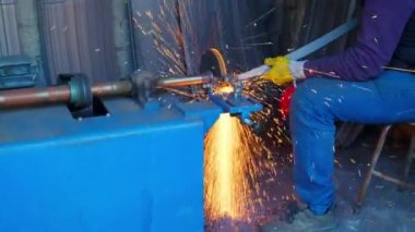 Close-up view of blacksmith sharpening a sword.