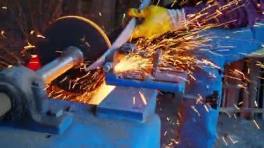 Close-up view of blacksmith sharpening a sword.