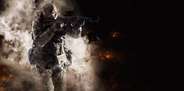 Special Forces soldier. Russian Special Operations fighter with AK-74 assault rifle aiming a machine gun on smoke background