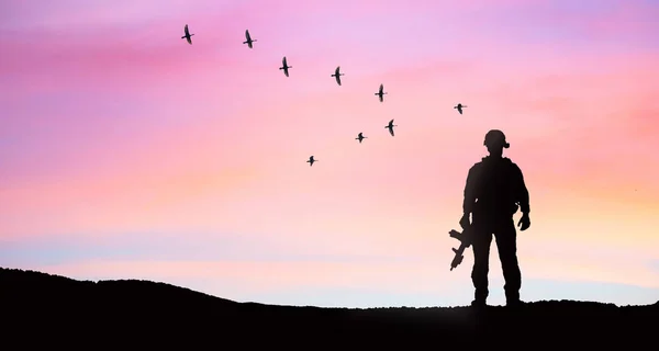 soldier silhouette on sunset sky background war peace concept