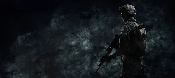Armed soldier on a dark background. Law and order protection concept. Special operation. swat