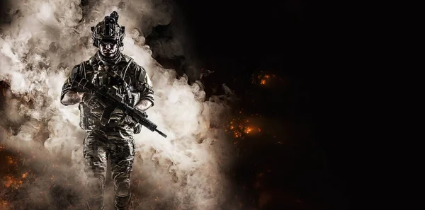 soldier fighter comes out of the smoke on the battlefield. united states military special operations. Computer games.