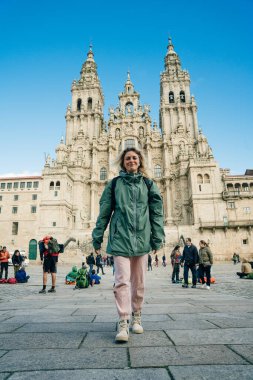 Backpackers and pilgrims looking at Santiago de Compostela Cathedral standing on the Obradeiro square. High quality photo
