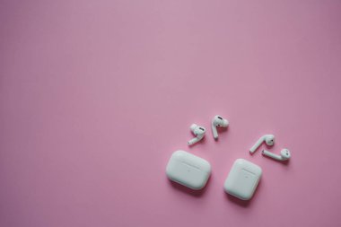 Kablosuz şarj kutusu olan beyaz kulaklıklar. Yeni hava araçları 2019-2020 siyah arka planda. Kadın ve erkek kulaklıkları. Uzayı kopyala - Telefon. Kanada - Mayıs, 2022