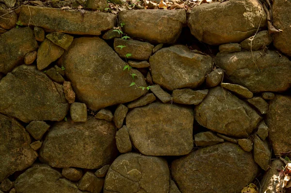 A texture background refers to the perceived feel, appearance or consistancy of the surface or subject. Pattern relates to the repetition of a graphic motif on a material. Here are some stones and rocks forming a beautiful texture pattern background.