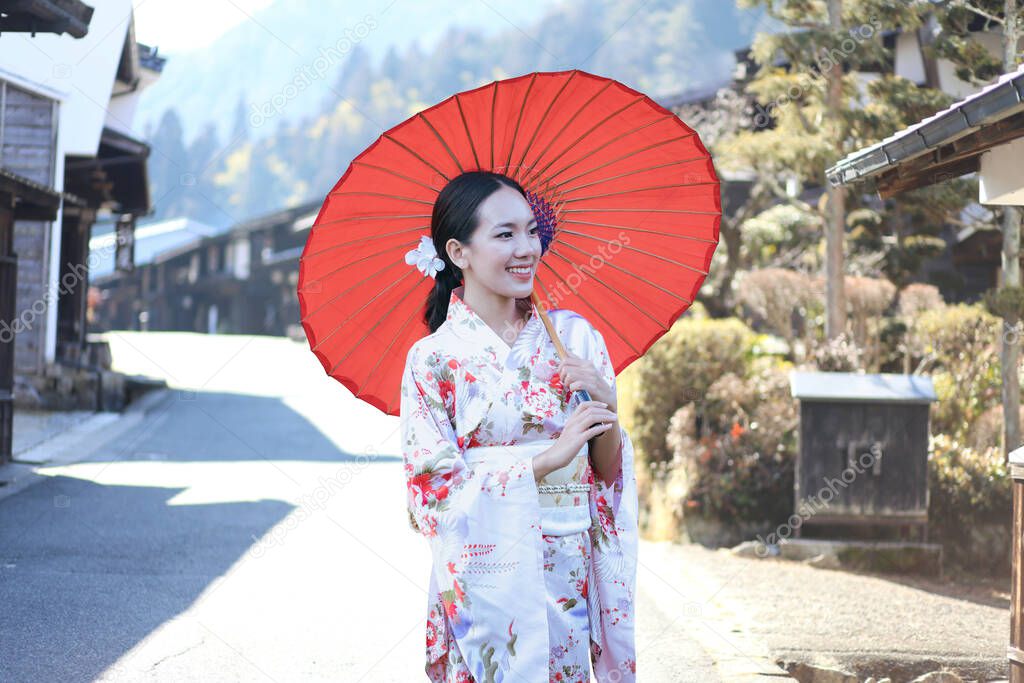 Asian woman tourists. Beautiful girl wearing traditional japanese kimono in Tsumago juku is now popular in village at Nagano Prefecture, Japan.