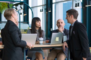 businessman Colleagues Meeting Team. business people talking in Co Working space office. Group of people in formalwear discussing something while working in the modern office.