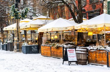 Gdansk, Polonya - 20 Ocak 2022: Gdansk 'ın tarihi pazar meydanındaki eski evlerin renkli cepheleri ve bir kafenin açık havası. Avrupa 'da popüler bir kafe ve restoran zinciri