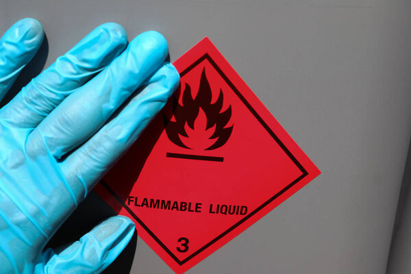 Labeling a sign on a chemical tank and flammable symbol 