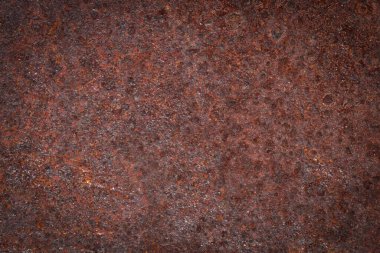 Eski metal yüzey ve arka planda kırmızı pas 