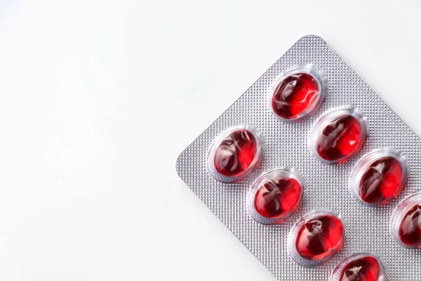 Léky Červené Kulaté Tablety Balení Tobolkách Pozadí — Stock fotografie