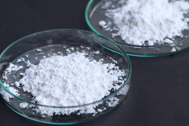 Calcium Carbonate powder is used in laboratory or in the industry  clipart