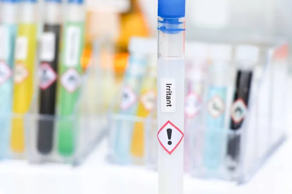 irritant chemical and symbol in test tube , chemical used in laboratory or industry