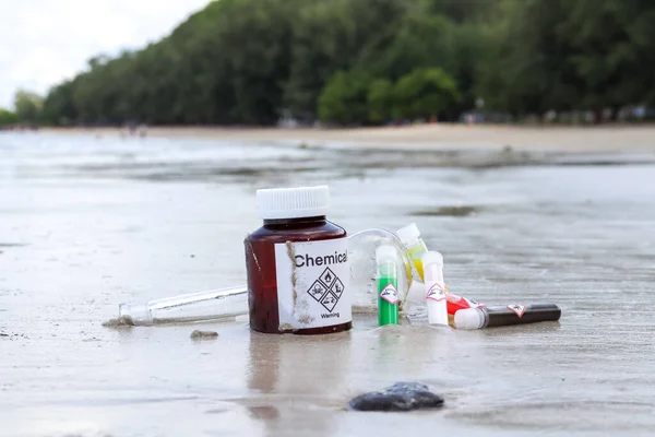 Chemical bottles from the lab were discarded on the beach and destroy the environment