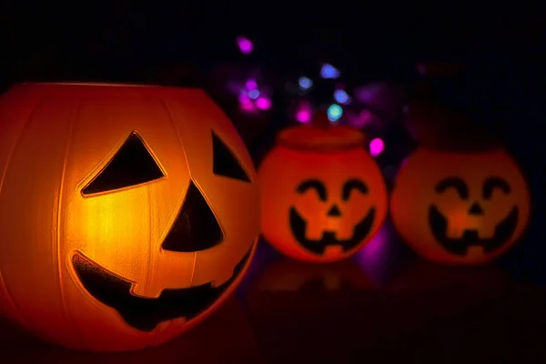 Halloween pumpkin smile and scary eyes for party night, bokeh background from lights at night