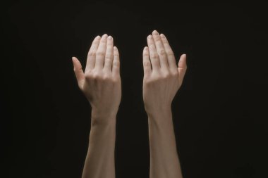 Praying hands to God in the dark. Woman hands reaching out to God or for help in barokko style