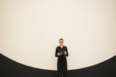 Minimalist ofis çalışma alanında tablet bilgisayar kullanan kadın